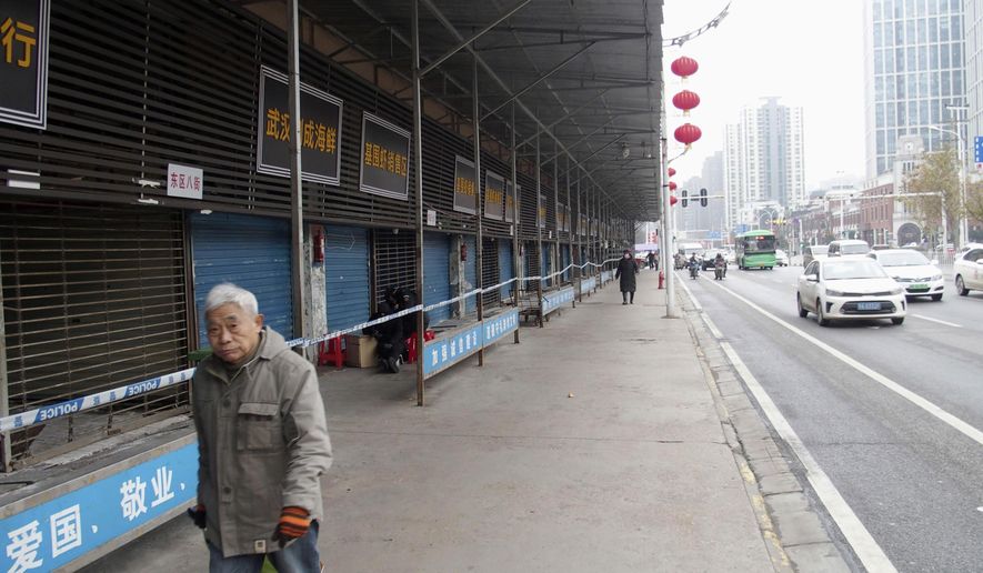 This Jan. 17, 2020, file photo, shows the closed Huanan Seafood Wholesale Market in Wuhan, China. China reported Monday, Jan. 20, a sharp rise in the number of people affected in a pneumonia outbreak caused by a new coronoavirus, including the first cases in the capital. (Kyodo News via AP)