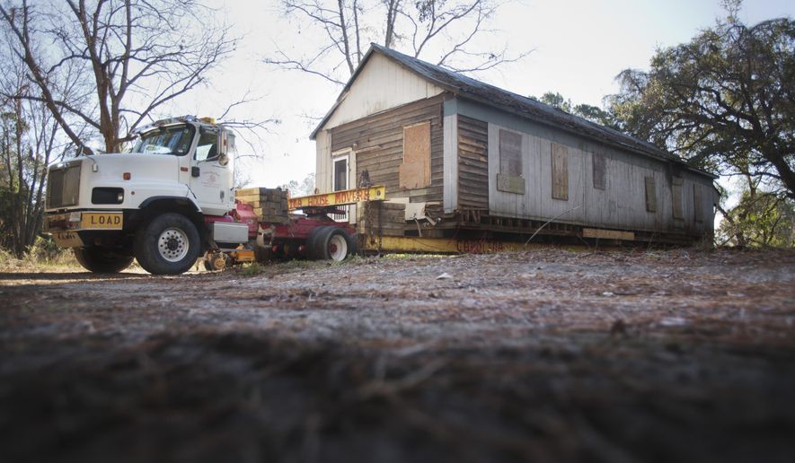 In this Tuesday Jan. 7, 2020 photo, the historic Long Point School in Mount Pleasant, S.C. is prepared to be moved. Efforts have been stalled to save the last standing African American school in Mount Pleasant, leaving some worried about the future of the dilapidated but historic institution. (Gavin McIntyre/The Post And Courier via AP)