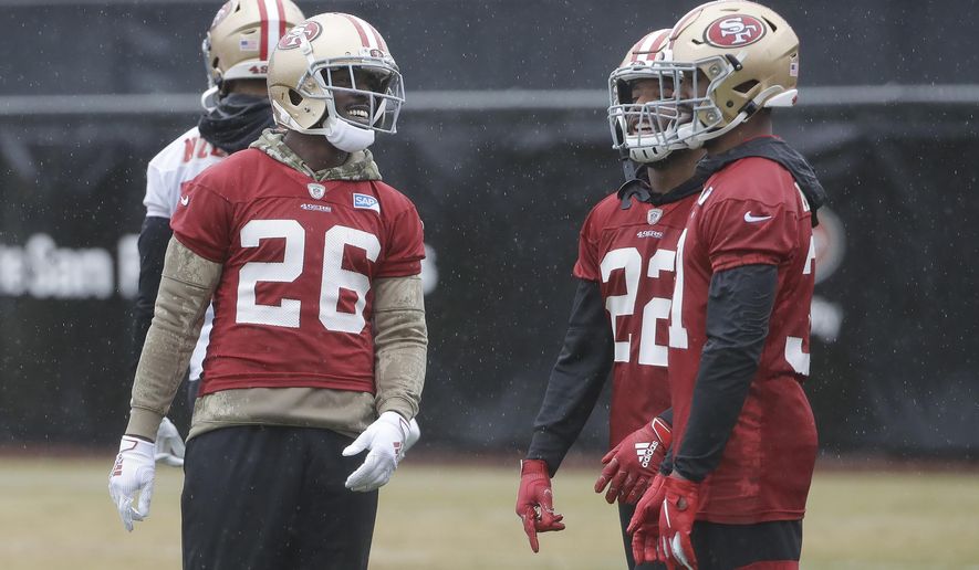 San Francisco 49ers running back Tevin Coleman (26) smiles next to Matt Breida (22) and Raheem Mostert during practice at the team's NFL football training facility in Santa Clara, Calif., Thursday, Jan. 16, 2020. The 49ers are scheduled to host the Green Bay Packers in the NFC Championship game Sunday. (AP Photo/Jeff Chiu)