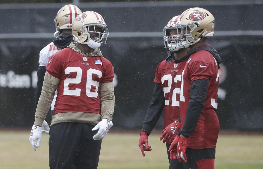 San Francisco 49ers running back Tevin Coleman (26) smiles next to Matt Breida (22) and Raheem Mostert during practice at the team's NFL football training facility in Santa Clara, Calif., Thursday, Jan. 16, 2020. The 49ers are scheduled to host the Green Bay Packers in the NFC Championship game Sunday. (AP Photo/Jeff Chiu)