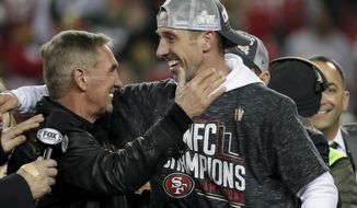 San Francisco 49ers head coach Kyle Shanahan celebrates with his dad, Mike, after the NFL NFC Championship football game against the Green Bay Packers Sunday, Jan. 19, 2020, in Santa Clara, Calif. The 49ers won 37-20 to advance to Super Bowl 54 against the Kansas City Chiefs. (AP Photo/Matt York)