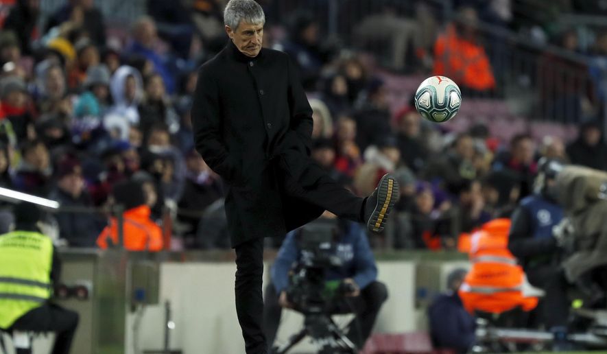 Barcelona&#x27;s head coach Quique Setien kicks the ball back to the pitch during a Spanish La Liga soccer match between Barcelona and Granada at Camp Nou stadium in Barcelona, Spain, Sunday, Jan. 19, 2020. (AP Photo/Joan Monfort)