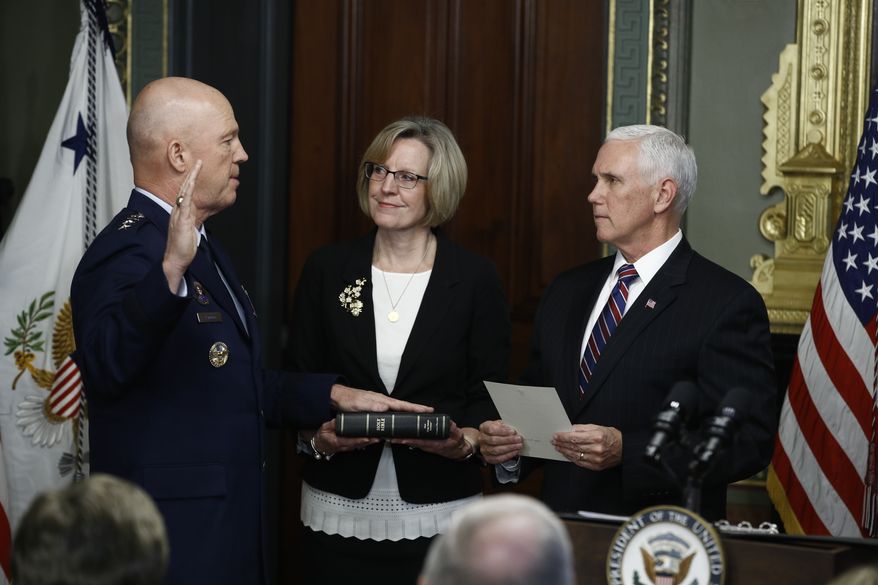Vice President Mike Pence, right, swears in Air Force General John Raymond as Chief of Space Operations, as his wife, Molly, center, holds a bible in the Vice President&#39;s Ceremonial Office at the Executive Office Building, Tuesday, Jan. 14, 2020 in Washington. (AP Photo/Steve Helber)  **FILE**


