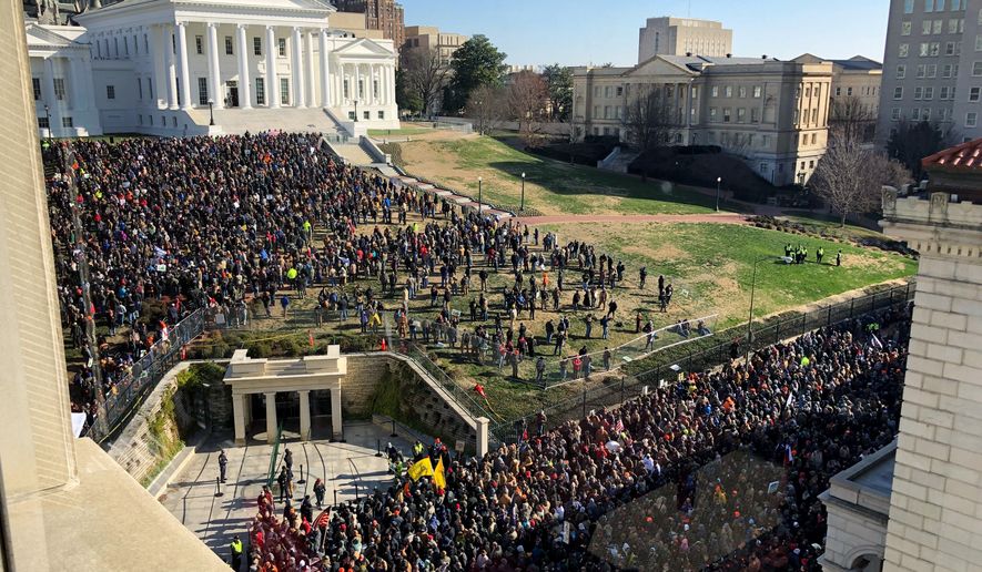 Demonstrators are seen during a pro-gun rally, Monday, Jan. 20, 2020, in Richmond, Va. Thousands of pro-gun supporters are expected at the rally to oppose gun control legislation like universal background checks that are being pushed by the newly elected Democratic legislature. (AP Photo/Sarah Rankin)