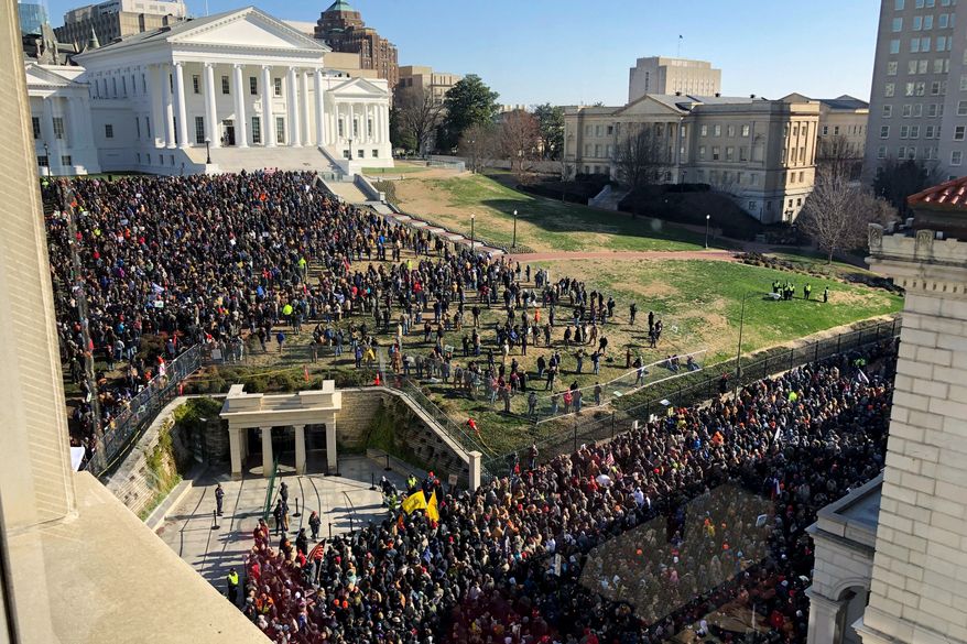 Demonstrators are seen during a pro-gun rally, Monday, Jan. 20, 2020, in Richmond, Va. Thousands of pro-gun supporters are expected at the rally to oppose gun control legislation like universal background checks that are being pushed by the newly elected Democratic legislature. (AP Photo/Sarah Rankin)