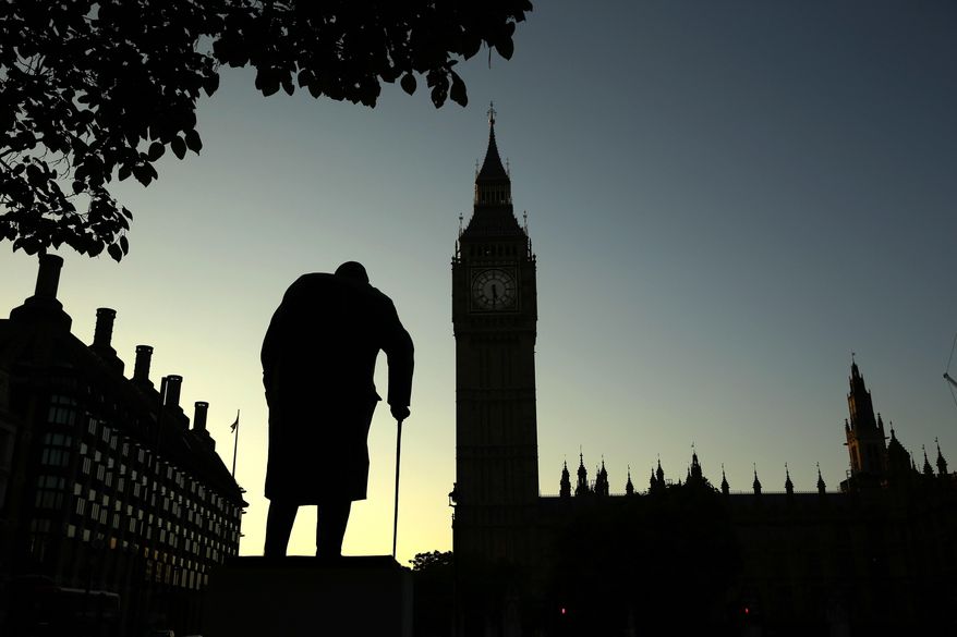 In this Friday, June 24, 2016, file photo a statue of Winston Churchill is silhouetted against the Houses of Parliament and the early morning sky in London, Friday, June 24, 2016. A day earlier, Britain had voted to leave the European Union in a referendum. On Jan. 31, 2020, Britain is scheduled to leave the EU after 47 years of membership. (AP Photo/Matt Dunham, File)