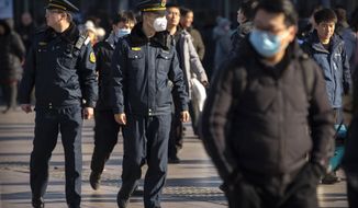 A security officer wears a face mask as he patrols outside of the Beijing Railway Station in Beijing, Monday, Jan. 20, 2020. China reported Monday a sharp rise in the number of people infected with a new coronavirus, including the first cases in the capital. The outbreak coincides with the country&#39;s busiest travel period, as millions board trains and planes for the Lunar New Year holidays. (AP Photo/Mark Schiefelbein)