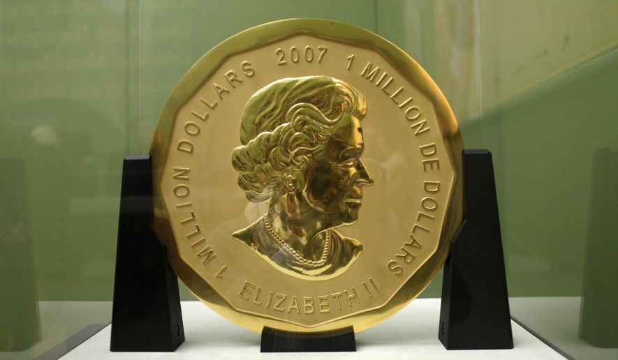 FILE -- In this Dec. 8, 2010 photo a 100-kilogram (221-pound) Canadian gold coin is displayed at the Bode Museum in Berlin, Germany. German prosecutors are seeking lengthy prison terms for four men accused of staging the brazen theft of a Canadian gold coin that disappeared from a Berlin museum almost three years ago. The 'Big Maple Leaf' coin, worth several million dollars, was stolen from the Bode Museum in March 2017. (Marcel Mettelsiefen/dpa via AP, file)