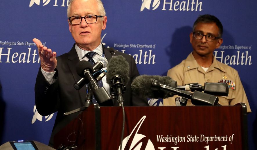 Dr. Jay Cook, Providence Regional Medical Center, in Everett, speaks at a news conference at the State of Washington&#39;s Department of Health Public Health Laboratories, Tuesday, Jan. 21, 2020, in Shoreline, Wash., while speaking on the condition of a patient who is in good condition with the coronavirus. At right is Dr. Satish Pillai, of the Center for Disease Control, in Atlanta. (Greg Gilbert/The Seattle Times via AP)