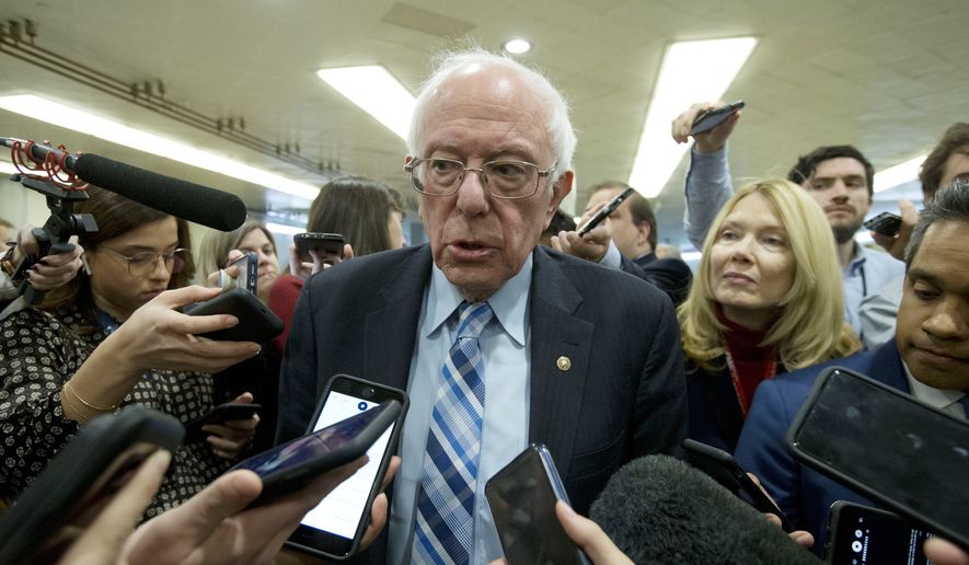Sen. Bernie Sanders, I-Vt., talks to reporters as he arrives at the Senate for the start of the impeachment trial of President Donald Trump on charges of abuse of power and obstruction of Congress, at the Capitol in Washington, Tuesday, Jan. 21, 2020.   (AP Photo/Jose Luis Magana)