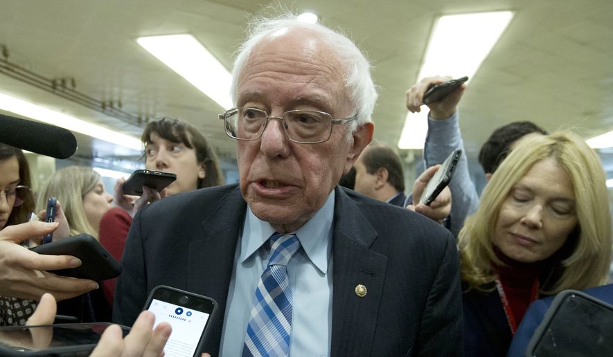 Sen. Bernie Sanders, I-Vt., talks to reporters as he arrives at the Senate for the start of the impeachment trial of President Donald Trump on charges of abuse of power and obstruction of Congress, at the Capitol in Washington, Tuesday, Jan. 21, 2020.  (AP Photo/Jose Luis Magana)