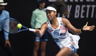 Japan&#39;s Naomi Osaka makes a forehand return to China&#39;s Zheng Saisai during their second round singles match at the Australian Open tennis championship in Melbourne, Australia, Wednesday, Jan. 22, 2020. (AP Photo/Andy Brownbill)