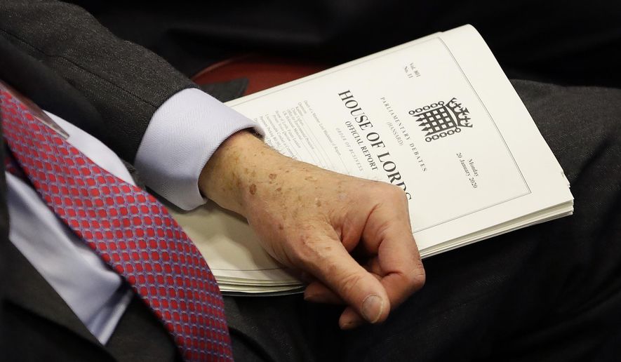 A member holds a document inside the House of Lords as the European Withdrawal Agreement Bill is debated in London, Tuesday, Jan. 21, 2020. Britain&#x27;s House of Lords is considering the European Withdrawal Agreement Bill, which is due to pass through its final stages before returning to the House of Commons. (AP Photo/Kirsty Wigglesworth, pool)