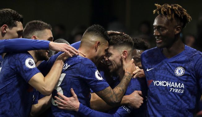 Chelsea&#x27;s Jorginho, second right, celebrates with teammates after scoring his side&#x27;s opening goal from the penalty spot during the English Premier League soccer match between Chelsea and Arsenal at Stamford Bridge Stadium in London, Tuesday, Jan. 21, 2020. (AP Photo/Matt Dunham)