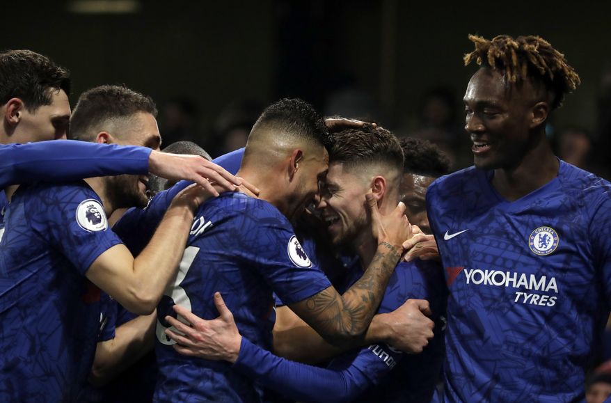 Chelsea&#x27;s Jorginho, second right, celebrates with teammates after scoring his side&#x27;s opening goal from the penalty spot during the English Premier League soccer match between Chelsea and Arsenal at Stamford Bridge Stadium in London, Tuesday, Jan. 21, 2020. (AP Photo/Matt Dunham)