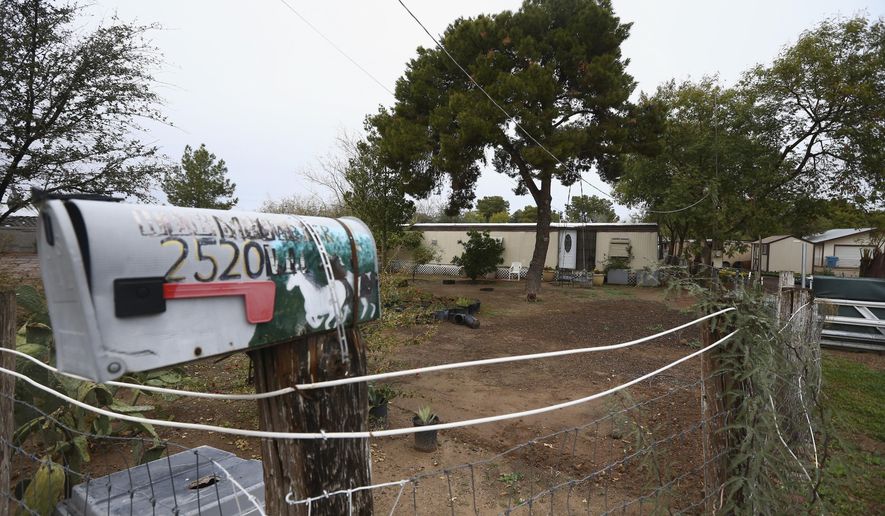 A Phoenix woman has been arrested on suspicion of killing her three children after they were found dead inside the family home at this location Tuesday, Jan. 21, 2020, in Phoenix. (AP Photo/Ross D. Franklin)