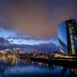 Clouds drift over the European Central Bank, right, in Frankfurt, Germany, Saturday, Jan. 18, 2020. (AP Photo/Michael Probst)