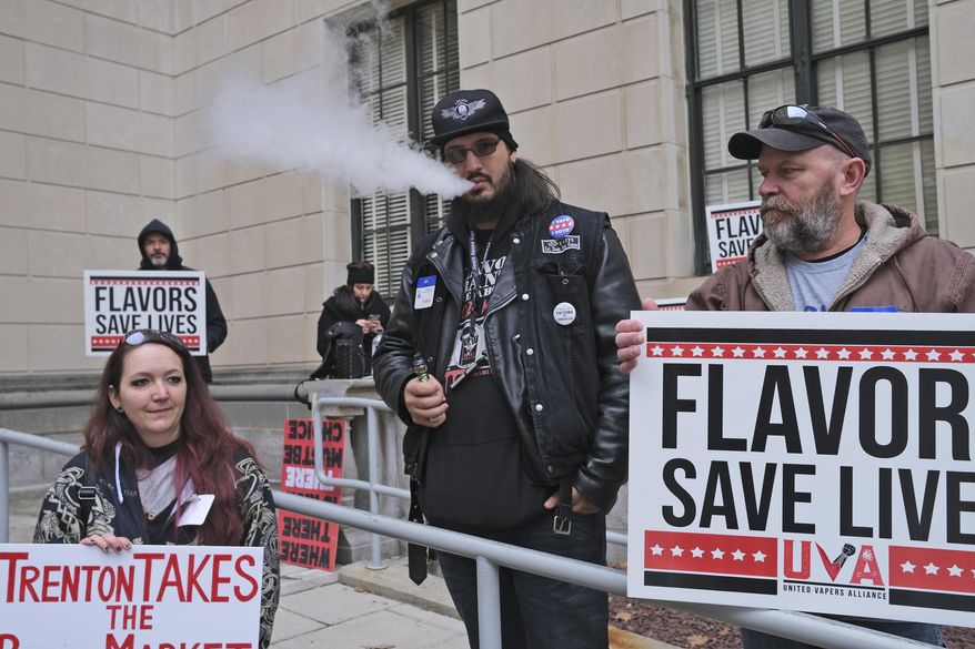 FILE - In this Jan. 13, 2020, file photo, Matthew Elliot, center, and other supporters of flavored vaping products protest at the state house in Trenton, N.J. New Jersey Democratic Gov. Phil Murphy has signed legislation on Tuesday, Jan. 21, 2020, prohibiting the sale of flavored vaping products. Murphy signed the measure that moved to his desk amid a nationwide scare last year over mysterious illnesses linked to vaping. The ban will take effect in April. (AP Photo/Seth Wenig, File)