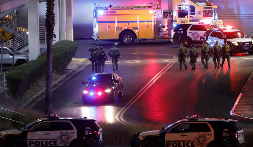 Las Vegas Metro Police officers head into the Fashion Show Mall on the Las Vegas Strip after a shooting at the mall in Las Vegas, Tuesday, Jan. 21, 2020. (Steve Marcus/Las Vegas Sun via AP)