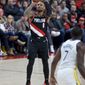 Portland Trail Blazers guard Damian Lillard shoots a 3-point basket against the Golden State Warriors during the second half of an NBA basketball game in Portland, Ore., Monday, Jan. 20, 2020. (AP Photo/Craig Mitchelldyer)