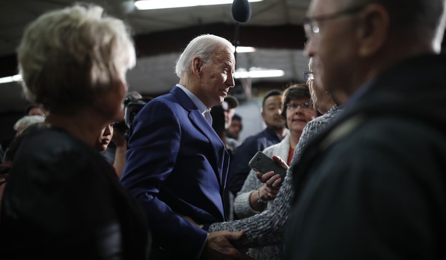Democratic presidential candidate former Vice President Joe Biden meets with people during a campaign event at the North Iowa Events Center, Wednesday, Jan. 22, 2020, in Mason City, Iowa. (AP Photo/John Locher)