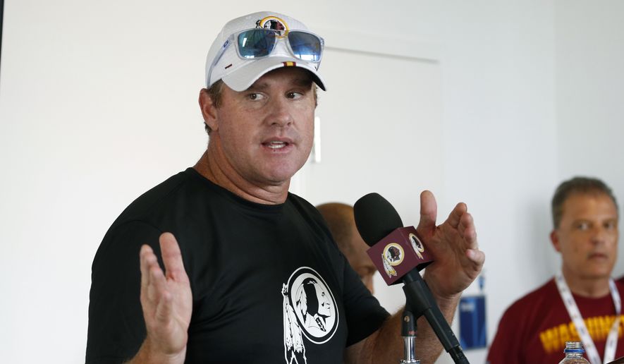 In this July 24, 2019, file photo, then-Washington Redskins head football coach Jay Gruden gestures during a news conference at the Redskins NFL training camp in Charlottesville, Va. The Jacksonville Jaguars have hired former Washington coach Jay Gruden as their offensive coordinator. Gruden signed his contract Wednesday, Jan. 22, 2020, and replaces John DeFilippo, who was fired earlier this month after just one season. (AP Photo/Steve Helber) ** FILE **
