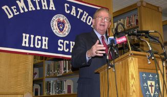 FILE - In this Nov. 6, 2002, file photo, Morgan Wootten, head basketball coach at DeMatha High School, speaks at a press conference to announce his stepping down as coach, in Hyattsville, Md. Wootten, a Hall of Fame coach who built DeMatha High School into a national powerhouse and mentored several future NBA stars during a career that spanned parts of six decades, has died. He was 88. The school announced his death on Twitter, writing, “The Wootten Family is saddened to share the news that their loving husband and father Morgan Wootten passed away&quot; on Tuesday night, Jan. 21, 2020. (AP Photo/Nick Wass, File)