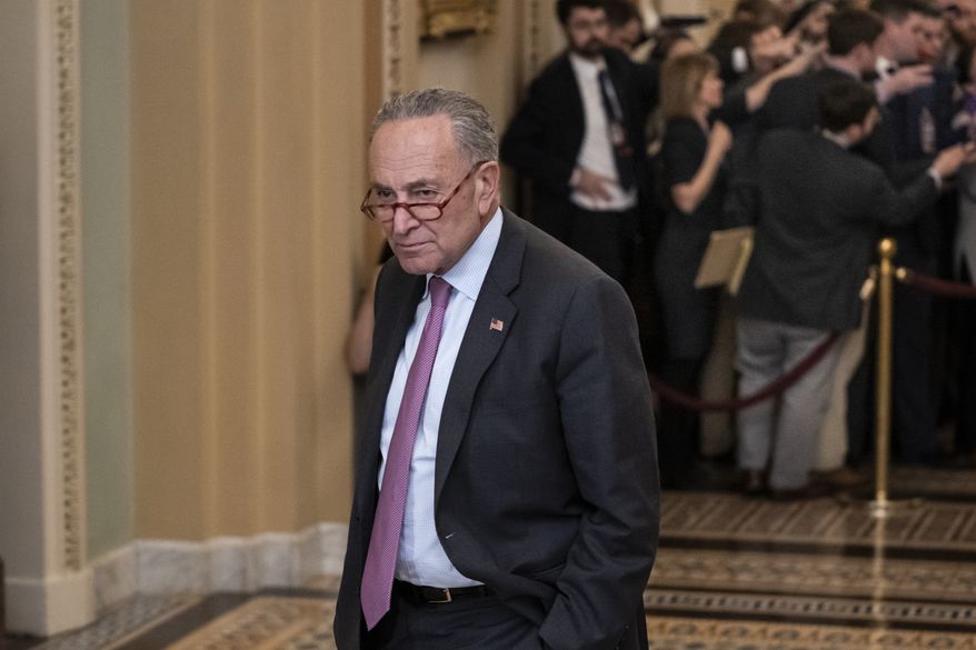 Senate Minority Leader Chuck Schumer, D-N.Y., pauses outside the Senate chamber during a break as the Senate continues with the impeachment trial of President Donald Trump on charges of abuse of power and obstruction of Congress, at the Capitol in Washington, Wednesday, Jan. 22, 2020. (AP Photo/J. Scott Applewhite)