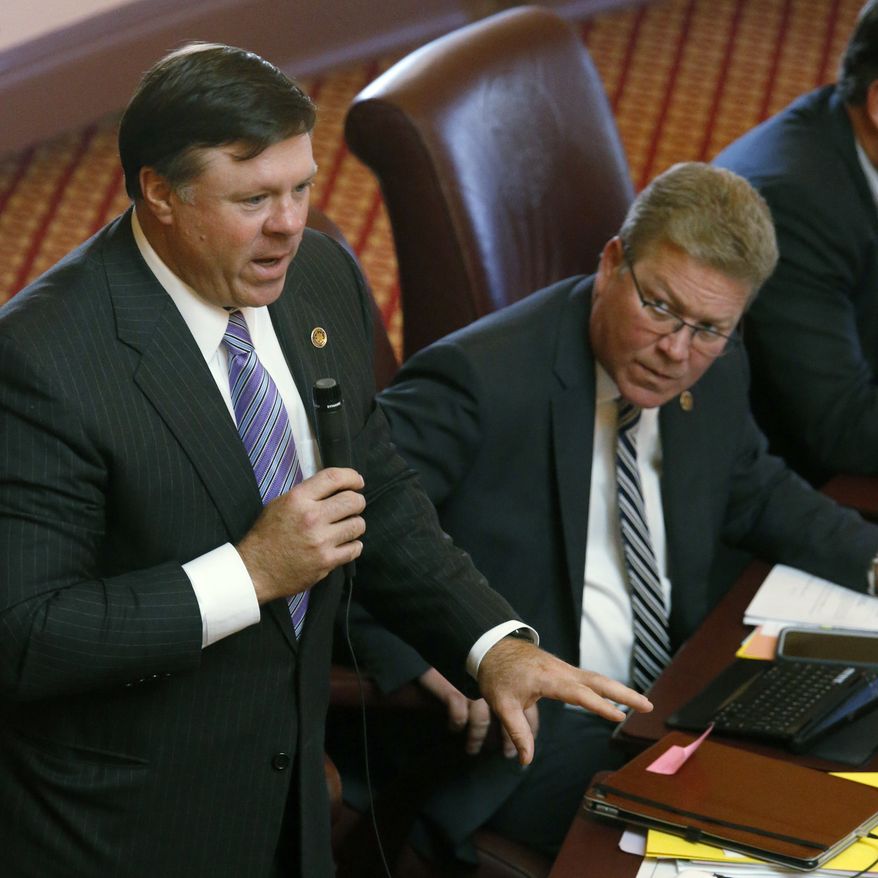State Sen. Bill Stanley, R-franklin, right, looks on as state Sen. Ryan McDougle, R-Hanover, left, speaks against SB240, the so-called &quot;Red Flag&quot; gun bill during debate in the Virginia Senate inside the state Capitol in Richmond, Va., Wednesday, Jan. 22, 2020. The bill passed on a party-line vote, 21-19 in favor of the Democrats. (Bob Brown/Richmond Times-Dispatch via AP)