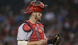 FILE - In this Sept. 25, 2019 file photo St. Louis Cardinals catcher Matt Wieters pauses behind home plate during the first inning of a baseball game against the Arizona Diamondbacks in Phoenix. The Cardinals signed Wieters to a contract for the 2020 season on Wednesday, Jan. 22, 2020 bringing back the 33-year-old veteran to fill the same role behind Yadier Molina as last season. (AP Photo/Ross D. Franklin, file)