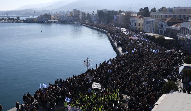 Protesters take part in a rally in the port of Mytilene, on the northeastern Aegean island of Lesbos, Greece, on Wednesday, Jan. 22, 2020. Local residents and business owners have launched a day of protest on the Greek islands hardest hit by migration, demanding the Greek government ease severe overcrowding at refugee camps. (AP Photo/Aggelos Barai)