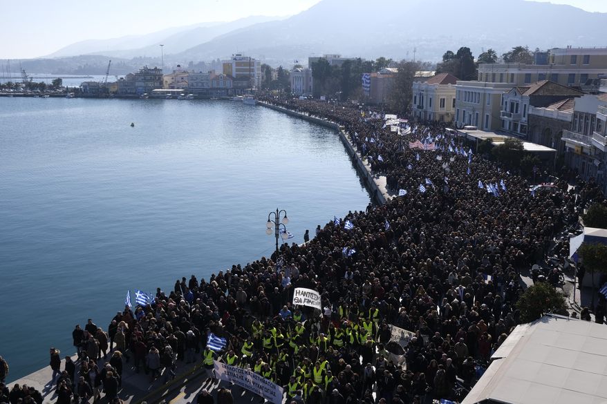Protesters take part in a rally in the port of Mytilene, on the northeastern Aegean island of Lesbos, Greece, on Wednesday, Jan. 22, 2020. Local residents and business owners have launched a day of protest on the Greek islands hardest hit by migration, demanding the Greek government ease severe overcrowding at refugee camps. (AP Photo/Aggelos Barai)