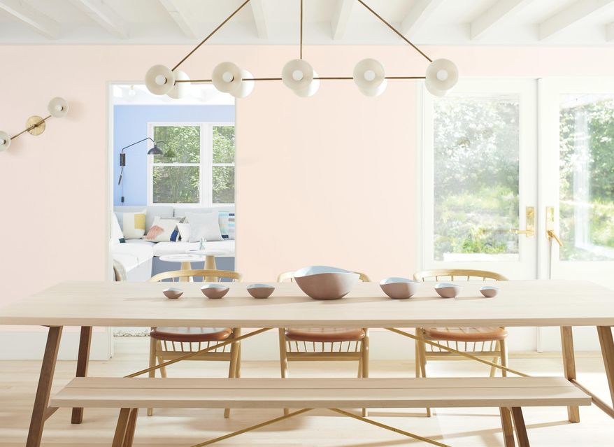 This photo provided by Benjamin Moore shows a room with Benjamin Moor'es 2020 Color of the Year called First Light, a dreamy, soft shade of pink. Director of Color Marketing & Development Andrea Magno says that while the color was already part of the 3500-hue library, "it's always fortuitous when the trend concept and color name complement one another. While descriptions like 'light pink' are quite straightforward, we also look for names that evoke positive associations and experiences." (Benjamin Moore via AP)