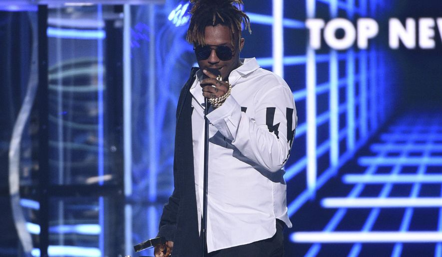 FILE - In this May 1, 2019 file photo, Juice WRLD accepts the award for top new artist at the Billboard Music Awards at the MGM Grand Garden Arena in Las Vegas. The Cook County Medical Examiner's office has determined that the death of rapper last month was the result of an accidental overdose of the opioid oxycodone and codeine. The Chicago-area rapper, whose real name is Jarad A. Higgins, was pronounced dead Dec. 8 after a "medical emergency'' at Chicago's Midway International Airport, according to authorities. (Photo by Chris Pizzello/Invision/AP, File)