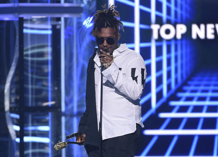 FILE - In this May 1, 2019 file photo, Juice WRLD accepts the award for top new artist at the Billboard Music Awards at the MGM Grand Garden Arena in Las Vegas. The Cook County Medical Examiner's office has determined that the death of rapper last month was the result of an accidental overdose of the opioid oxycodone and codeine. The Chicago-area rapper, whose real name is Jarad A. Higgins, was pronounced dead Dec. 8 after a "medical emergency'' at Chicago's Midway International Airport, according to authorities. (Photo by Chris Pizzello/Invision/AP, File)