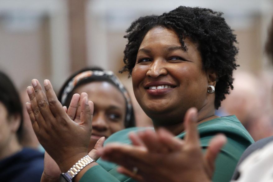 Stacey Abrams, a Georgia Democrat who has launched a multimillion-dollar effort to combat voter suppression, applauds a dignitary at the University of New England, Wednesday, Jan. 22, 2020 in Portland, Maine. Abrams was a Georgia state legislator who became the first black woman to win a major party gubernatorial nomination in U.S. history. (AP Photo/Robert F. Bukaty)