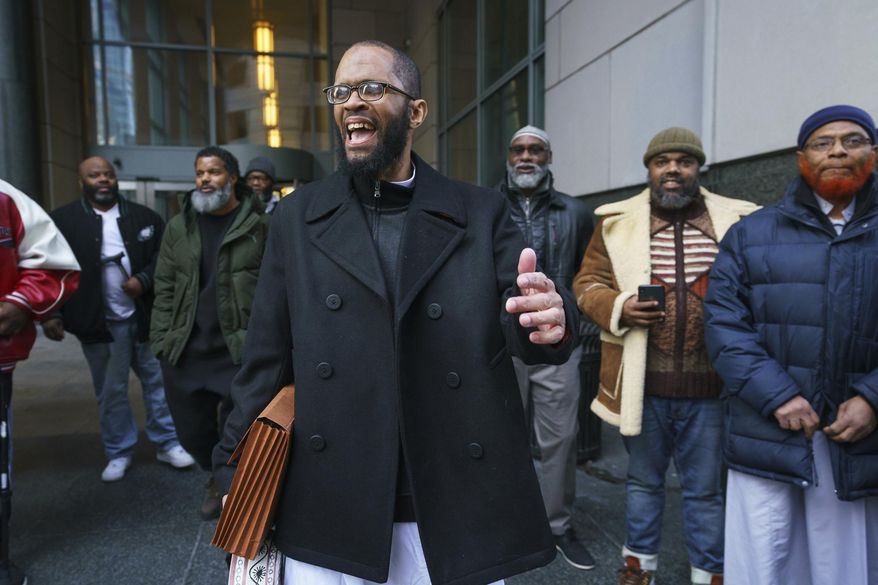 Theophalis Wilson, with friends and family behind him, walks out of the Criminal Justice Center in Philadelphia on Tuesday, Jan. 21, 2020, after being exonerated for a triple murder that took place when he was 17 years old, for which he served 21 years in prison. (Jessica Griffin/The Philadelphia Inquirer via AP)