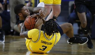 Michigan guard Zavier Simpson (3) and Penn State guard Myles Dread (2) battle for a loose ball in the first half of an NCAA college basketball game in Ann Arbor, Mich., Wednesday, Jan. 22, 2020. (AP Photo/Paul Sancya)