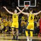 Iowa&#39;s Luka Garza (55) and CJ Fredrick (5) celebrate in front of Rutgers&#39; Jacob Young (42) at the end of an NCAA college basketball game, Wednesday, Jan. 22, 2020, in Iowa City, Iowa. Iowa won 85-80. (AP Photo/Charlie Neibergall)