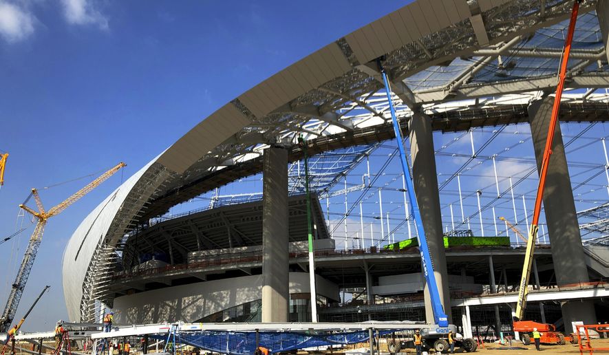 Workers and cranes continue construction on the south entrance to SoFi Stadium in Inglewood, Calif., on Wednesday, Jan. 22, 2020. The estimated $5 billion project is on schedule to open in July as the most expensive stadium in NFL history. (AP Photo/Greg Beacham)