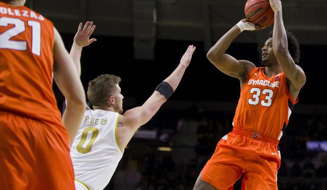 Syracuse&#x27;s Elijah Hughes (33) shoots over Notre Dame&#x27;s Rex Pflueger (0) during the second half of an NCAA college basketball game Wednesday, Jan. 22, 2020, in South Bend, Ind. Syracuse won 84-82. (AP Photo/Robert Franklin)