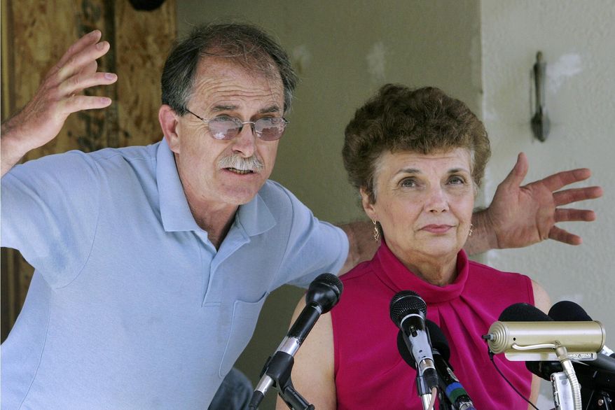 FILE - In this June 18, 2007, file photo, Ed and Elaine Brown talk to reporters during a news conference at their home in Plainfield, N.H. Years after they were imprisoned for amassing an arsenal of weapons at their fortress-like home, and holding U.S. marshals at bay after a tax evasion conviction, Elaine Brown said she is ashamed of her actions and seeks a divorce while awaiting re-sentencing in 2020 in light of a recent U.S. Supreme Court ruling. (AP Photo/Jim Cole, File)