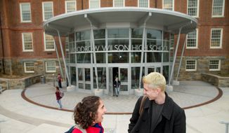 High School juniors Brian Keyes and Isabel Suarez, both 16, pose for a photograph in front of Woodrow Wilson High School in Washington, Thursday, March 3, 2016, after recently taking the new SAT exam. (AP Photo/Andrew Harnik) **FILE**


