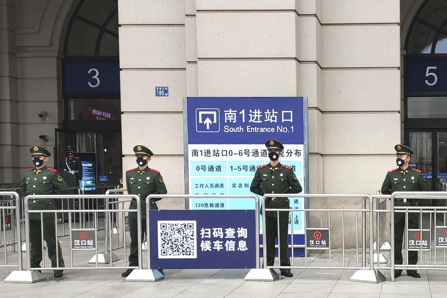 Paramilitary police stand guard at an entrance to the closed Hankou Railway Station in Wuhan in central China&#x27;s Hubei Province, Thursday, Jan. 23, 2020. China closed off a city of more than 11 million people Thursday in an unprecedented effort to try to contain a deadly new viral illness that has sickened hundreds and spread to other cities and countries in the Lunar New Year travel rush. (Thepaper via AP)