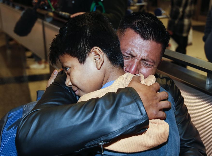 David Xol-Cholom, of Guatemala hugs his son Byron at Los Angeles International Airport as they reunite after being separated about one and half year ago during the Trump administration&#39;s wide-scale separation of immigrant families, Wednesday, Jan. 22, 2020, in Los Angeles. (AP Photo/Ringo H.W. Chiu)