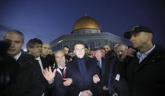 French President Emmanuel Macron, center, visits the al-Aqsa mosque compound in Jerusalem, Wednesday, Jan. 22, 2020. Dozens of world leaders have descended upon Jerusalem for the largest-ever gathering focused on commemorating the Holocaust and combating modern-day anti-Semitism. (AP Photo/Mahmoud Illean)