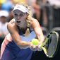 Denmark&#39;s Caroline Wozniacki makes a backhand return to Tunisia&#39;s Ons Jabeur in their third round singles match at the Australian Open tennis championship in Melbourne, Australia, Friday, Jan. 24, 2020. (AP Photo/Andy Brownbill)
