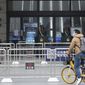 A man rides his bicycle past the closed Hankou Railway Station in Wuhan in central China&#39;s Hubei Province, Thursday, Jan. 23, 2020. Overnight, Wuhan authorities announced that the airport and train stations would be closed, and all public transportation suspended by 10 a.m. Friday. Unless they had a special reason, the government said, residents should not leave Wuhan, the sprawling central Chinese city of 11 million that&#39;s the epicenter of an epidemic that has infected nearly 600 people. (Chinatopix via AP)