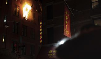 Fire blows out of a window in the Chinatown section of New York, Thursday, Jan. 23, 2020. New York City firefighters battled a raging blaze at a building in the city&#39;s Chinatown area Thursday night, Firefighters said they were called about 8:45 p.m. to 70 Mulberry Street for a fire on the fourth and fifth floors of the building, NYFD officials said. (AP Photo/Robert Bumsted)