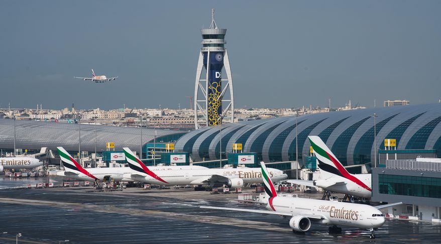 FILE - In this Dec. 11, 2019, file photo, an Emirates jetliner comes in for landing at Dubai International Airport in Dubai, United Arab Emirates. Dubai International Airport, the world&#39;s busiest for international travel, said Thursday, Jan. 23, 2020, that it is taking special precautions to screen the droves of Chinese tourists expected for the Lunar New Year holiday after the outbreak of a pneumonia-like virus that has led to China&#39;s lockdown of the entire city of Wuhan. (AP Photo/Jon Gambrell, File)